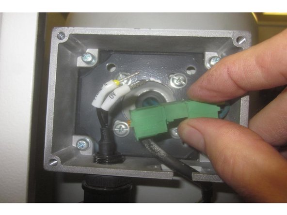 Connect up the fan wires to the tan colored connector. Depress the orange tabs and push in the wire. Blue wires on one side and black on the other. Note: The wires install in either position on the same side.