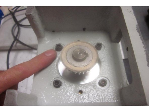 Using a 3/16 hex tool, remove the four (4) 1/4-20 SHCS that fasten the mounting bracket to the motor. These screws have Loctite on the threads. Use care removing them as the motor side thread is aluminum.