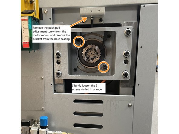 Crack Loose the two(2) motor mounting screws that allow for rotational adjustment of the motor on the motor mounting bracket. (Circled in orange). Rotate the motor so that the electrical box is facing downward. Snug up the screws. Remove the push pull adjustment screw from the motor mount and then remove the push/pull bracket from the base casting.