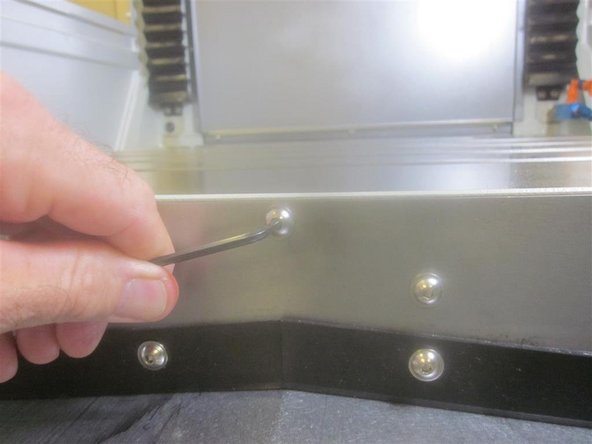 Remove the sheet metal wiper covers (both front and rear) from the table.