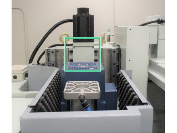 Remove the coupler cover from the motor mounting bracket located behind the spindle drive motor. The coupler slot should be facing outward toward the front of the machine.