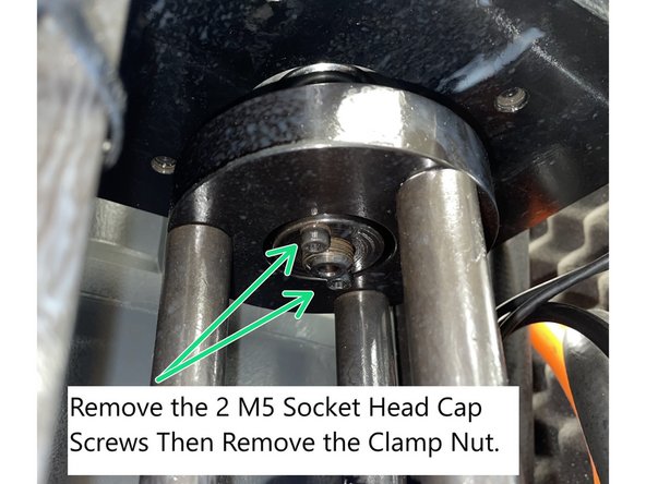 Remove the (2) socket head screws securing the clamp nut to the upper plate. Unscrew and remove the clamp nut (left-hand thread). Unscrew and remove the cage from the air cylinder (left-hand thread). Photo 1
