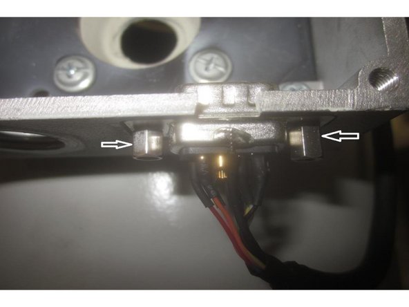 Using a 5mm 1/4 drive socket and 5mm open end wrench, remove the two (2) small nuts and jack screws retaining the encoder cable D-sub to the junction box. Use caution as these components are easily stripped or lost.  Note: The junction box is threaded where the jack screws attach.