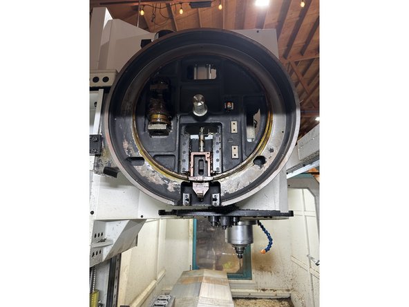 Slide the replacement carousel plate onto the machine, ensuring the segmentation cam and bearings are properly aligned.