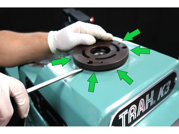 Carefully pry around the plate to lift it off the machine.