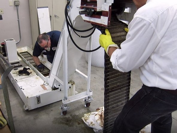 Reinstall the belt in the conveyor on the bottom side of the drive sprockets. Continue pushing the belt into the conveyor until it comes out on the top side of the drive sprocket at the far end of the conveyor. You may need assistance getting the belt around this bend.