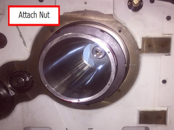 Thread nut onto spindle and tighten with brass punch or screwdriver and plastic tipped hammer