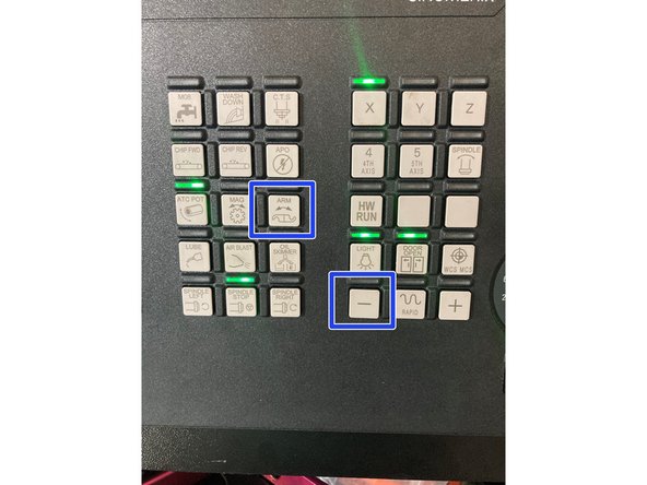 This procedure is best performed with two people. One person will press and hold the Green manual tool change button on the head of the machine.