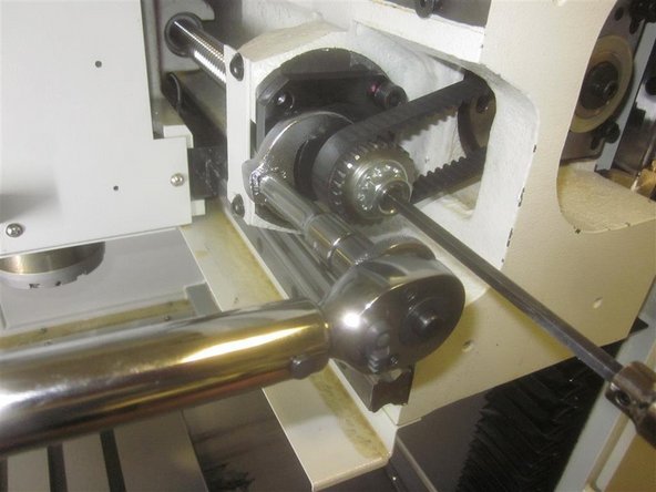 Go to service code 505, and adjust the X motor to 180 (or the number you noted earlier. Rotate the ball screw until it touches the RH cushion, and let it relax. Back it off exactly one full turn, so the limit switch just lights. Install the belt and tension it, so it can only twist 45 deg. Torque the X motor plate screws to 10 ft. lbs.