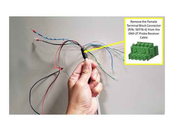 Before routing the cable, remove the Female Terminal Block Connector (P/N: 50776-4) from the end of the OMI-2T cable, and tape the wires together to help the cable pass through the knockout hole and machine cable troughs.