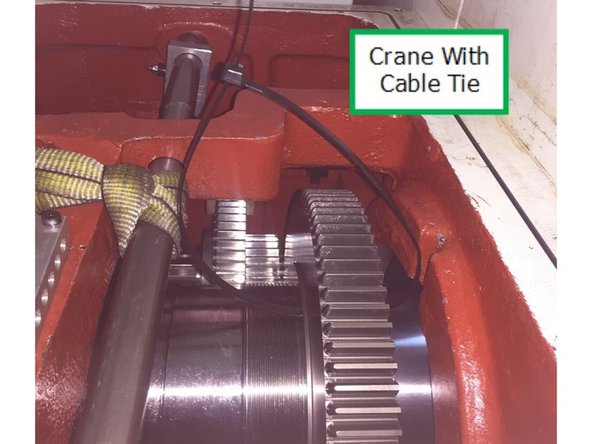 Install the 48” heavy duty cable tie through low gear at the keyway in the gear and connect the ends of the cable tie to create loop so this can be used as a handle to help remove low gear from the spindle and out of the headstock.