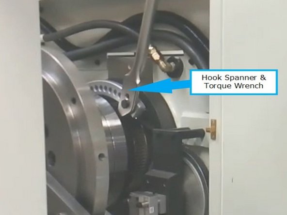 Loosen the set screws on the spindle bearing lock nut.