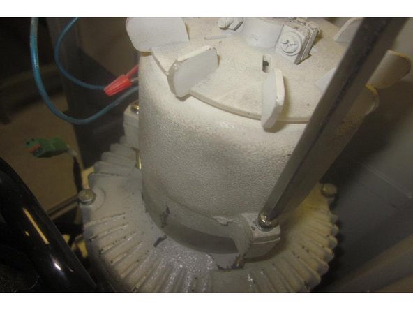 Loosen off the three screws that attach the fan to the motor. Lift off the fan. Remove the spacer (marked for reference) and guide it over the encoder cable.