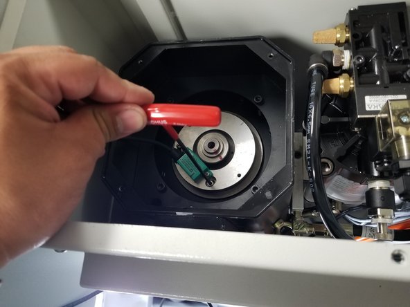 Use the same 3mm long T-handle hex key and carefully loosen the two (2) 4mm SHCS that fasten the Encoder Plate Assembly to the motor until they are out of their thread. Let them sit in their slots. DO NOT ATTEMPT TO REMOVE THE HARDWARE FROM THE PLATE ASSEMBLY. This reduces the chance of dropping hardware down in the motor.