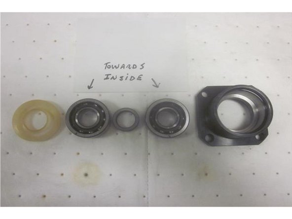 Lube all fasteners prior to installation. Inspect the new ball screw for damage. Position the ball nut in approximately the same place as the old one. If replacing the upper angular contact bearings (recommended), make sure they are greased and orientated correctly with the spacer in between and the outer seal open side out.