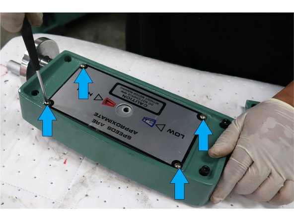 Remove the four Philips head screws  to remove the front plate and speed dial.
