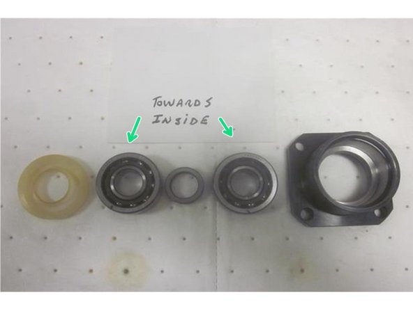 Lube all fasteners prior to installation. Inspect the new ball screw for damage. Position the ball nut in approximately the same place as the old one. If replacing the upper angular contact bearings (recommended), make sure they are greased and orientated correctly with the spacer in between and install the outer seal open side out.