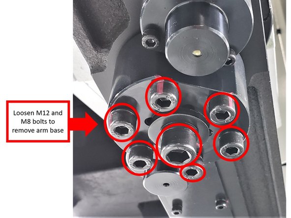 Next, loosen and remove the center M12 and six (6) M8 bolts on the arm base. Remove the base from the ATC shaft. Spray WD-40 on perimeter of ATC shaft and up into arm.