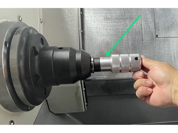 The 5C collets have a keyway in them that corresponds with the drive key(Silver M5 SHCS) in the collet chuck. When the collet is installed and adjusted the collet is oriented so the tip of the drive key fits into the keyway. The drive key is then tightened to prevent the collet from coming loose during operation.