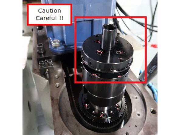 Carefully wrap spindle to place it in position. Wrapping the spindle protects its side and the top plate.