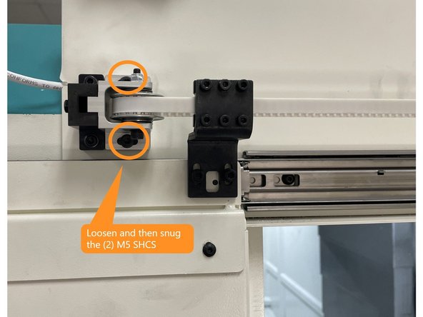 Loosen the two(2 ) M5 screws that mount the idler pulley assy to the base plate and then lightly snug them.