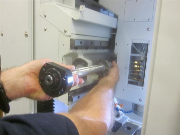 Remove the roller bearing and housing as a unit with the ball screw. Remove the ball screw by sliding it out from the LH side of the machine.