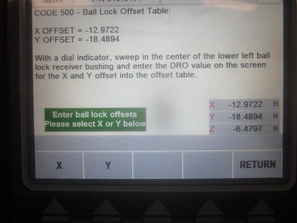 Use the hand wheel to sweep in the indicator to the center of the front LH ball lock. Once in position, select X axis, and enter the number from the DRO in the lower RH corner. Select Y-Axis, and enter the coordinating number in the DRO. Press ABS SET.