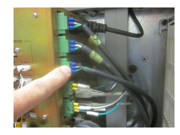 Disconnect the power and encoder cables from the computer module inside the electrical panel.