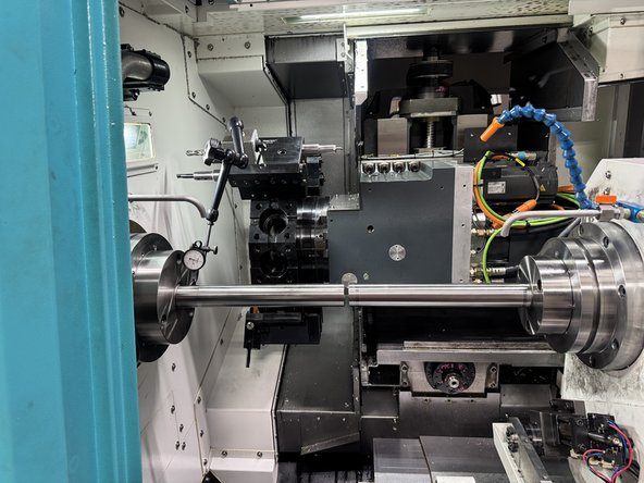Install a dial indicator to the turret and move the Z1 axis so that the indicator can measure the test bar closest to the Main Spindle face. Set up the indicator to measure the spindle runout.
