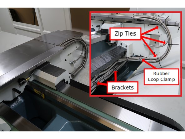 Cross slide cover top and bottom in place, hose clamps in place. and cable carrier organized to move back and forth with the table and keep hoses safe and tidy. Organize logic cable and hoses as shown using zip ties and removes ends.