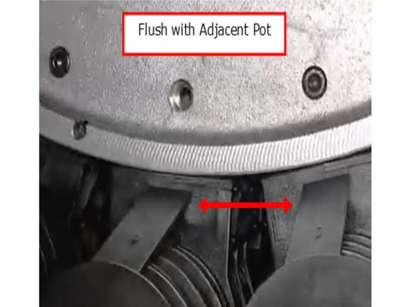Swing the pot upwards into position and pull it forward until it is flush with neighboring pots and touching the inside of the carousel.