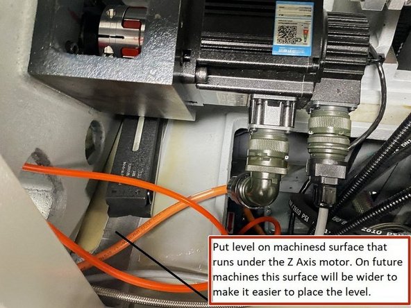 To level the machine in the X or short Axis one level is placed on the machined surface that runs under the Z Axis motor.