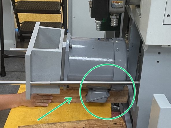 With the mounting bracket, adapter plate and pulley installed on the new motor, put it onto the lifting device used to remove it and position the motor back onto the installation and removal bars.