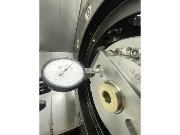 Using a tenths indicator, tram the turret using the ground oblong pockets on the face of the disk.