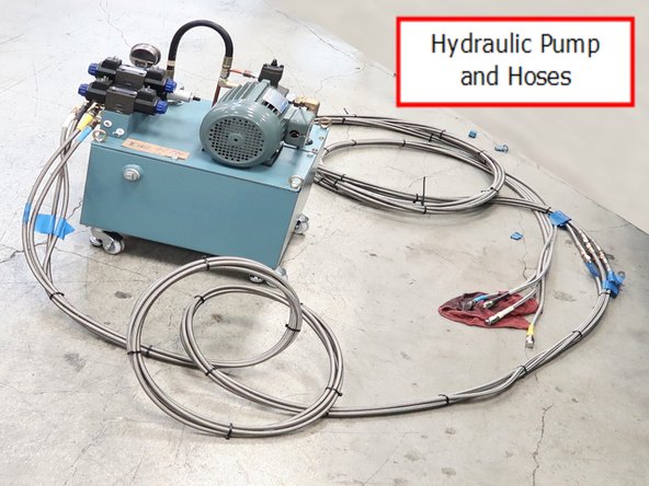 Pump with four hydraulic hose lines are routed through lathe along with a coolant line and turret logic cable. It is suggested that the installer start from the rear of the 30120 to route the hoses. It is difficult to start from the turret end because of lifting the heavy hoses through the lathe.
