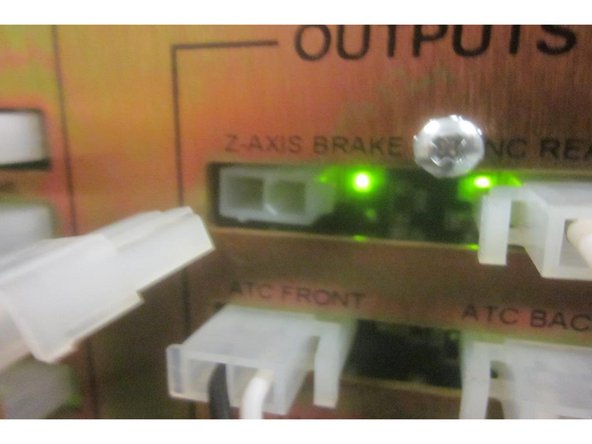 If the number is out of spec, lower the Z axis near the bottom of travel stopping at the number. Disconnect the Z brake wire at the computer module. Loosen the lower coupler screws. Use the hand wheel to adjust the index angle to 180. Tighten the coupler screws. Connect the Z axis brake wire at the computer module.