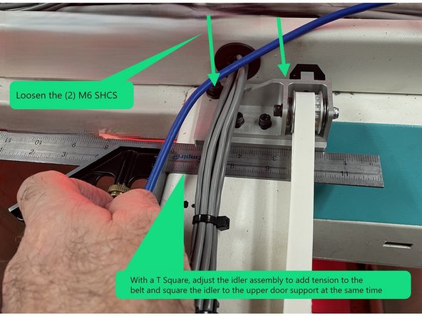 Loosen the 2 M6X16 SHCS in the idler base plate assembly. Using a T Square push the idler base plate to the right to remove any slack in the belt and square the Idler base assembly to the upper door support sheet metal at the same time . See photo 2.