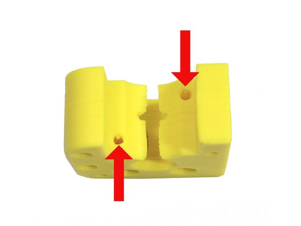 Ream the two holes indicated in the second photo - do not drill past the nut trap slot.