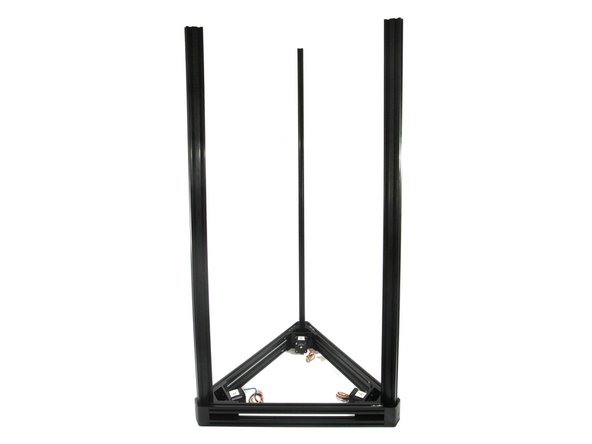 The end of the tower with the tape-marked threaded hole inserts into the base. The threaded hole should be on the outside edge of the base bracket as shown in the photo.