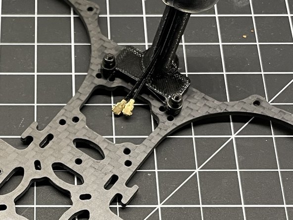 Insert M2x8 screws thru the bottom plate and thru the TPU antenna mount as shown, add nylon washer, and secure with M2 lock nut