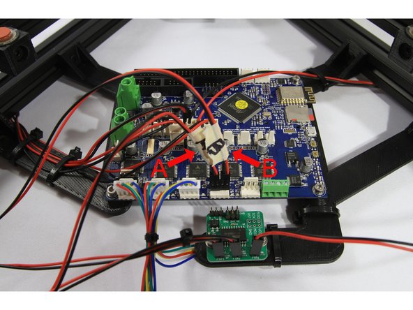 Connect the extruder stepper motor connectors marked A and B as shown in the first photo. The black wire must be on the left side for both connectors.