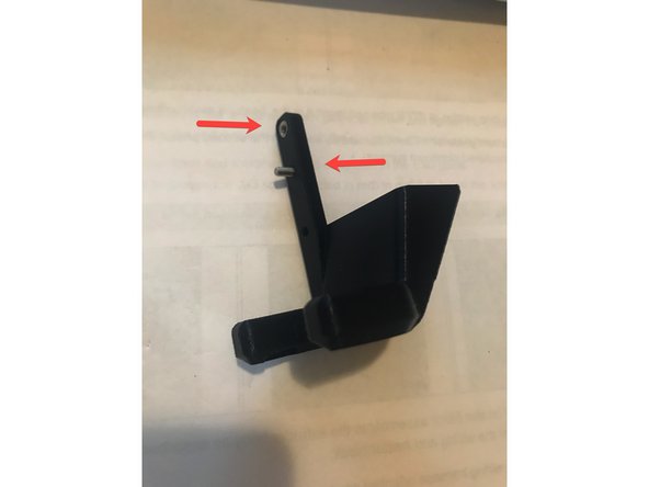 Locate the two rectangular holes on the side near the extruder gear. Insert 2 M3 Jam Nuts. (photo 1)