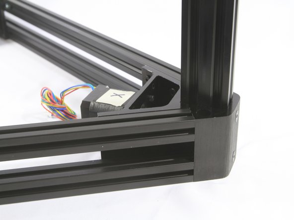 Align the T-nuts in the X corner bracket so the tower extrusion slot can slide onto them.