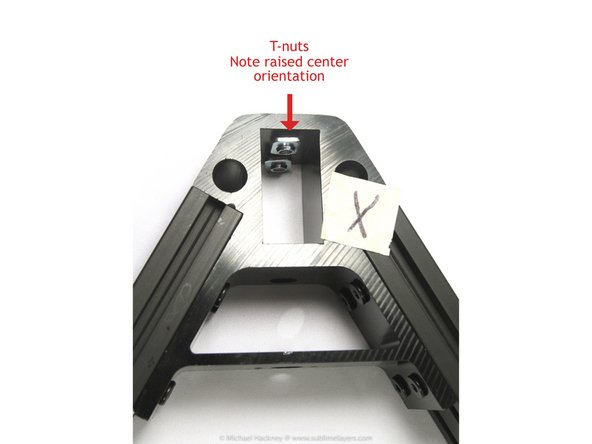 Loosely install two screws and T-nuts in the holes for the tower extrusion slot in each corner bracket in both the base and top assemblies. The T-nut goes inside the slot.
