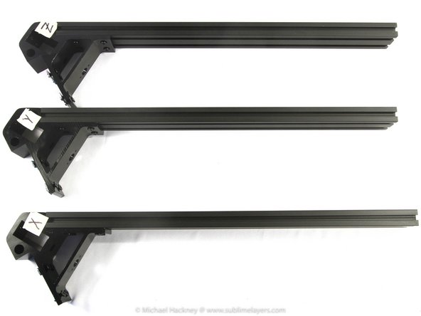 Locate the three rectangular frame extrusions. Attach one extrusion to  the right side of each top corner bracket exactly as you did for the base corner brackets.