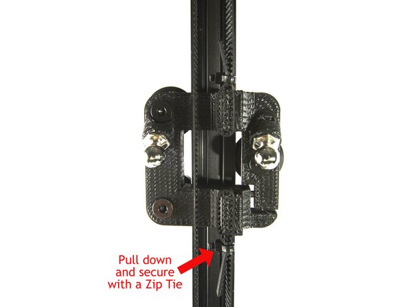 Pass the belt around the pulley on the stepper motor as shown in the second photo. Make sure the teeth are engaged.