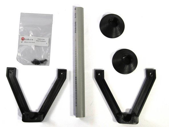 Locate the left and right filament spool brackets, the two spool cones, the Spool Hardware bag and the spool axle (grey PVC tubing).