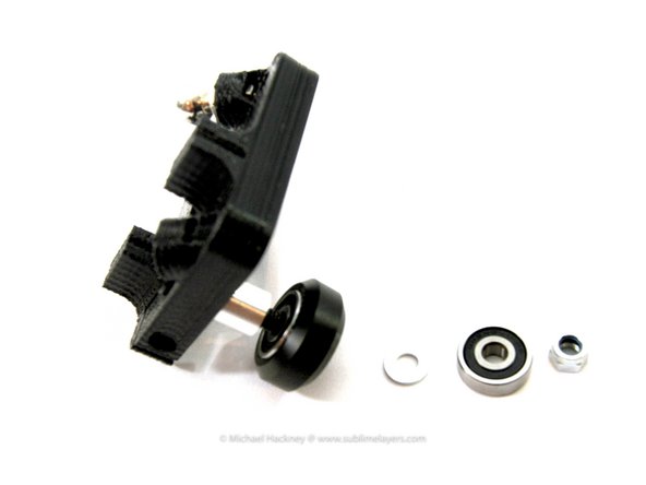 The assembly order is: spacer | bearing | ''Delrin™ wheel | spacer washer | bearing | lock nut''