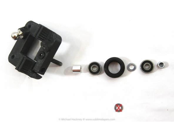 Insert one of the M5 wheel axle screws into the carriage as shown. The photo shows the assembly order for the wheel. Each of the Open Builds wheel bags contains the parts for one wheel in .