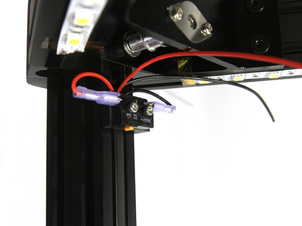 The idler pulley holes in the top brackets must be closest to the bottom of the frame as indicated in the photo.